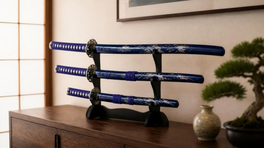 Blue dragon samurai sword set displayed on a three-tier tabletop stand on a walnut sideboard, handles to the left